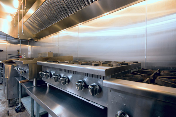 How often should commercial kitchen hoods be cleaned?